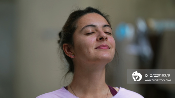 Meditative woman eyes closed taking a deep breath out contemplative person