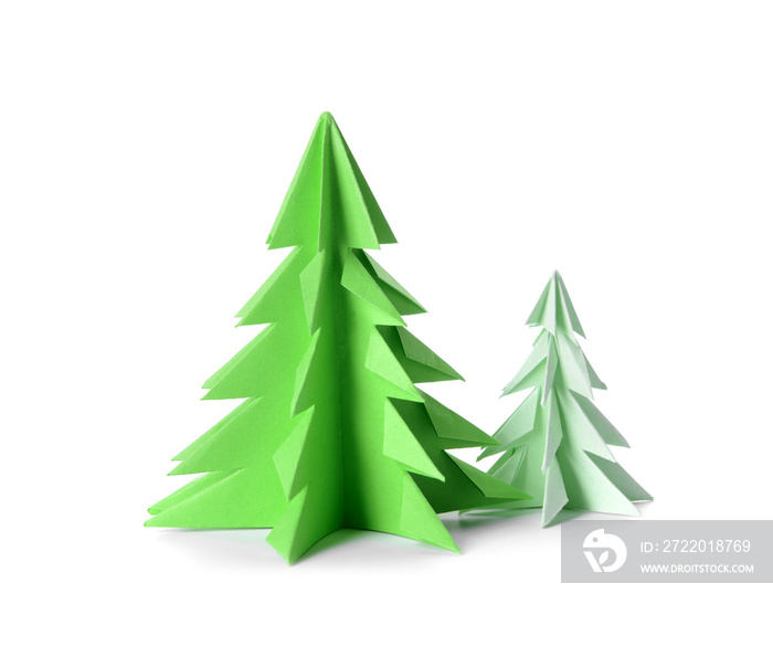 Green origami fir trees on white background