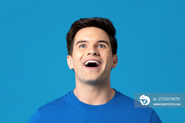 Delighted man looking up with mouth open