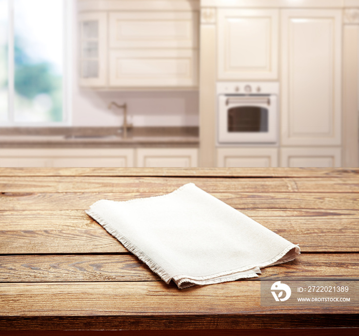 Empty white table cloth on wooden desk. Kitchen background.