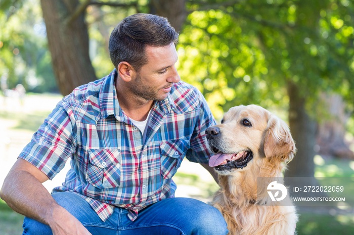 Happy man with his pet dog in park