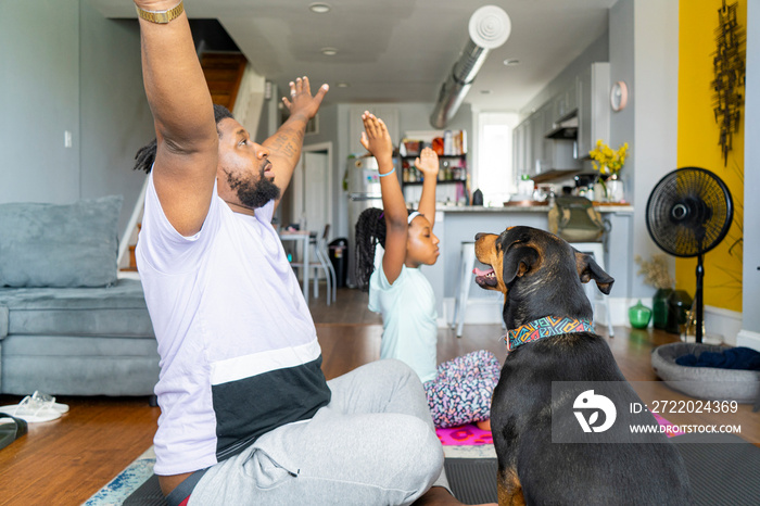 Father and daughter Êpracticing yoga at home