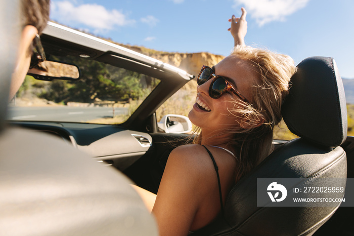 Woman enjoying on a roadtrip with her boyfriend