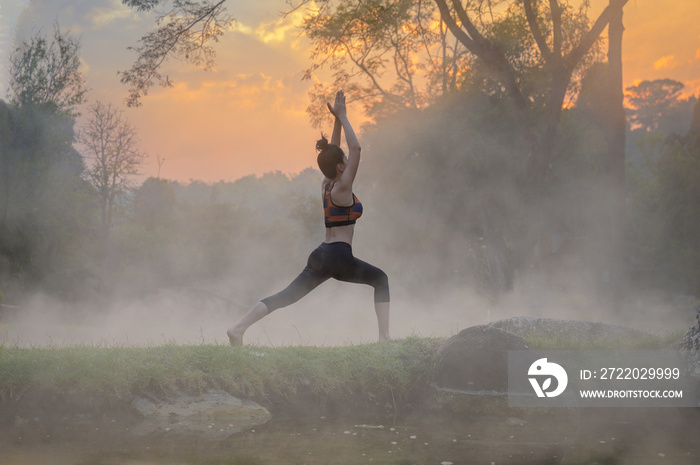 young woman in action of yoga practice in steaming hot spring water, the nature yoga exercise in hot