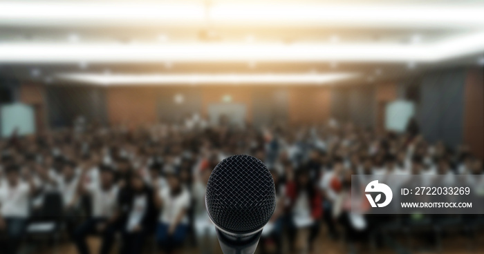 Microphone over the Abstract blurred photo of conference hall or seminar room with attendee backgrou