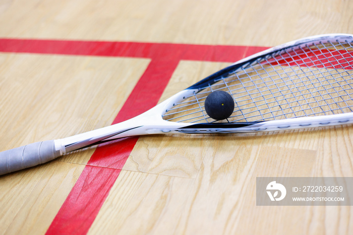 squash racket and ball on the court