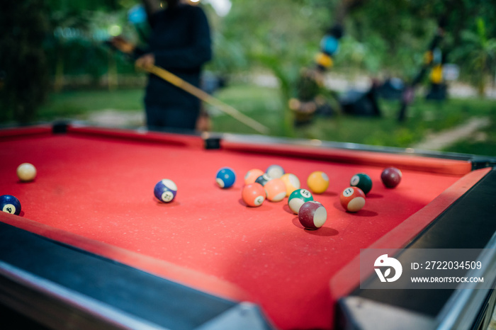 Queer masculine women playing pool