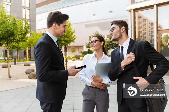 Office colleagues talking outdoors at the city streets