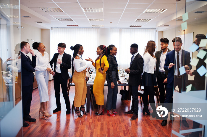 Large group of eleven multiracial business people standing at office. Diverse group of employees in 