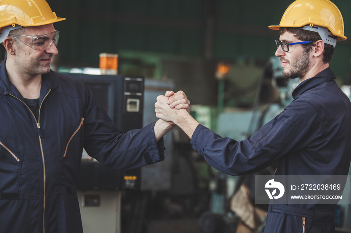 male workers and protective uniform shaking hands while working success teamwork collaboration. Two 