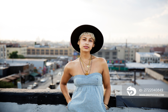 Portrait of woman wearing hat standing outdoors