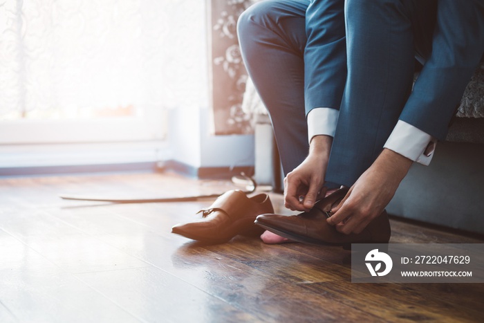 Groom dressing up with classic elegant shoes.