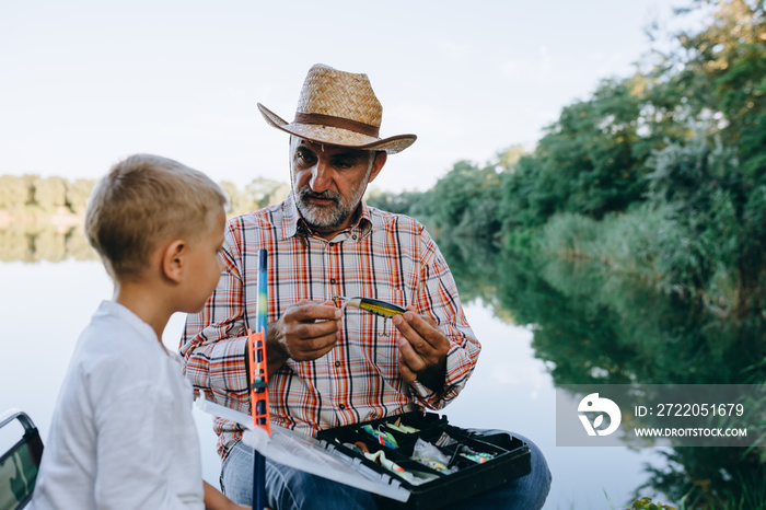 爷爷和孙子在湖上户外钓鱼