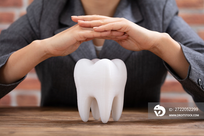 Womans Hand Protecting White Tooth