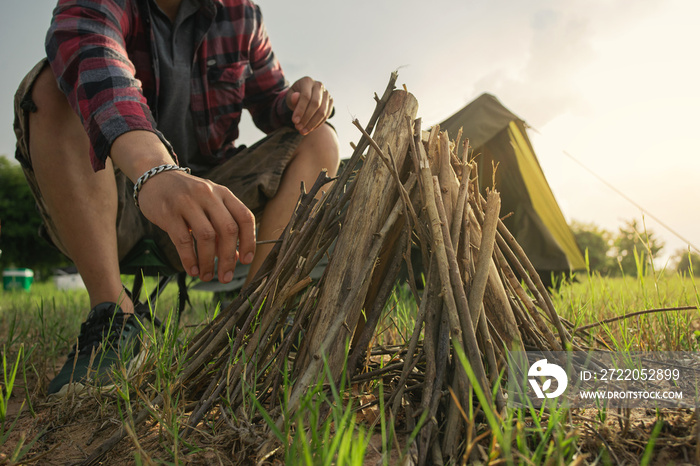 Selective focus, Bonfire with biomass wood material for campfire. A man tourist making bonfire and s