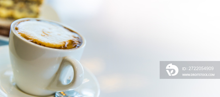 Cup of coffee and cake on the table