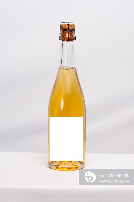 Full champagne wine bottle mock up with blank label on white table background