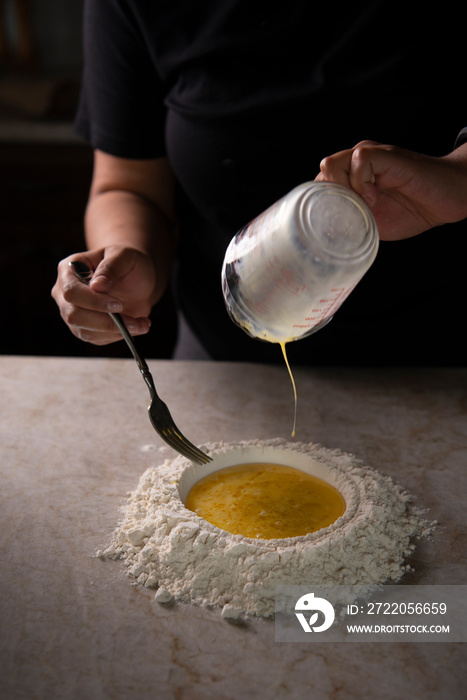 Chef pouring over flour