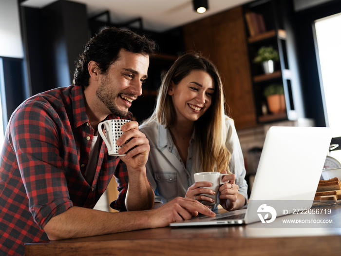 Loving couple drinking coffe in the kitchen. Happy smiling wife enjoy in the morning with her husban