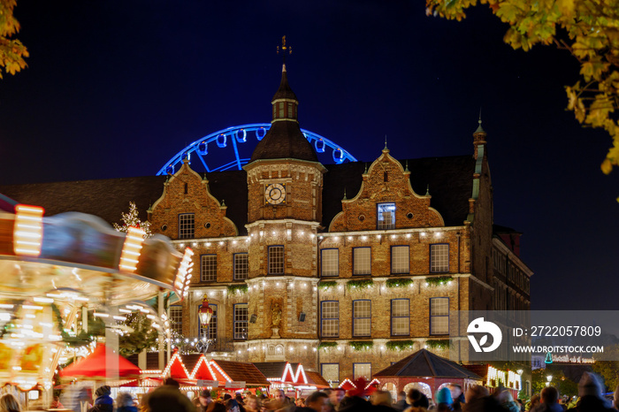 Night colourful atmosphere of Weihnachtsmarkt, Christmas market in Düsseldorf, with carousel, stalls