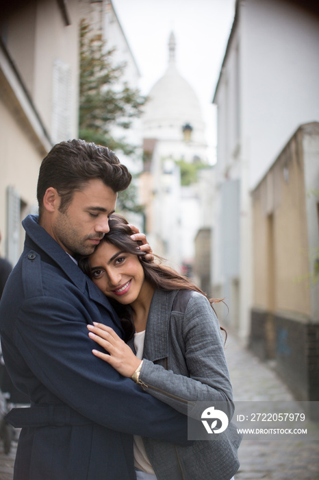 Affectionate couple hugging on Montmartre street, Paris, France