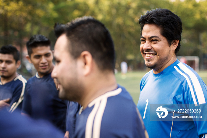 Smiling soccer players standing outdoors