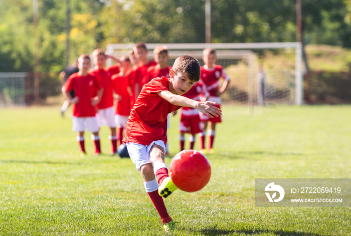 Young boy shooting soccer ball