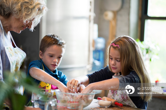 Children (6-7) cooking with grandmother