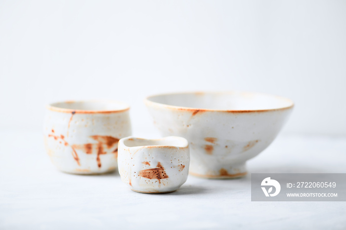 Traditional, handcrafted ceramic on bright wooden background. Soft focus. Copy space.