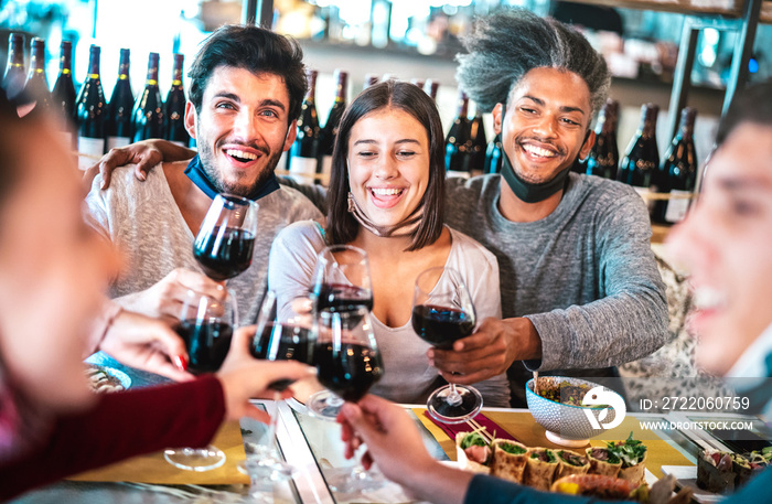People toasting red wine at restaurant sushi bar with open mask - New normal lifestyle concept with 