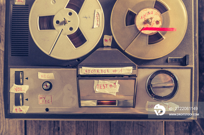 Retro audio reel recorder with roll of tape and microphone