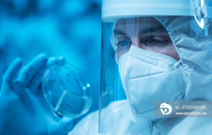 Scientist works in a modern scientific lab using laboratory equipment, microscope and computer techn