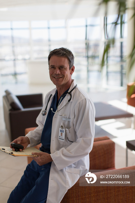 Portrait confident male doctor in hospital lobby