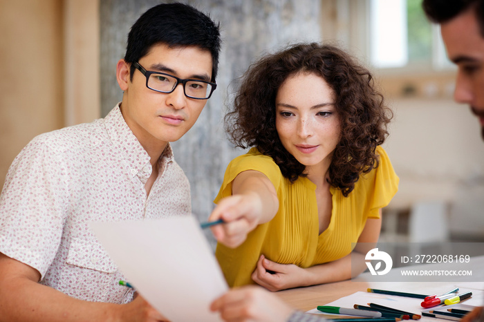 Businesswoman pointing at paper sheet during meeting