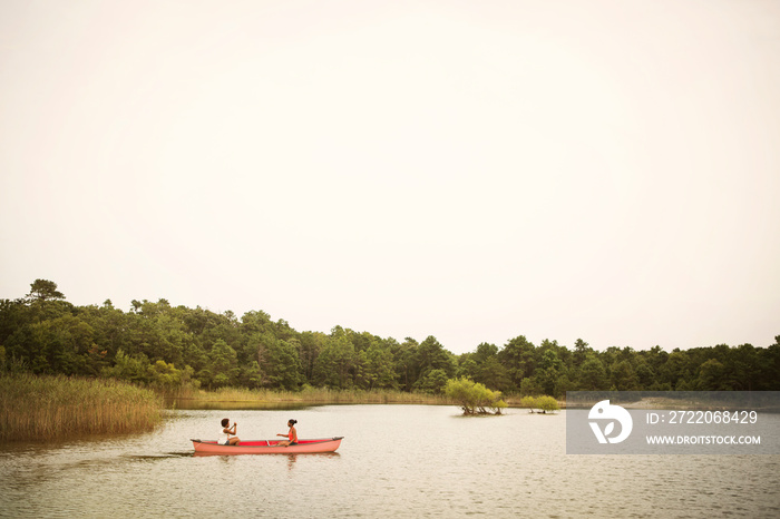 Friends canoeing in river