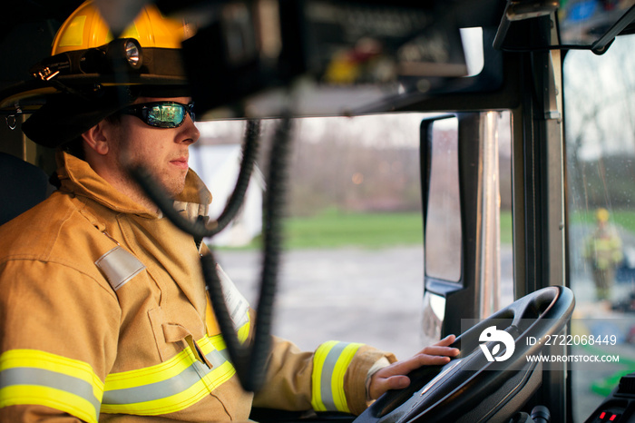 Firefighter sitting in fire engine