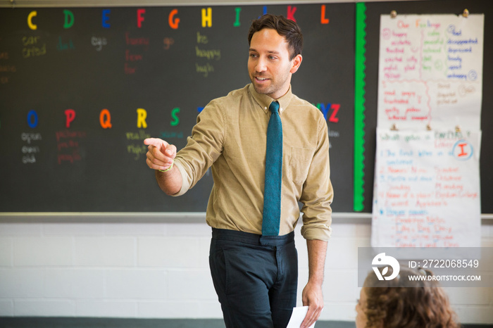 Elementary school teacher standing in classroom