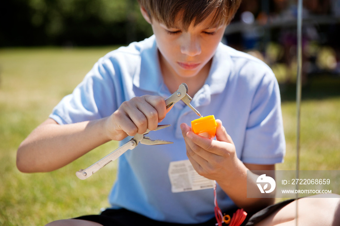 Young boy (10-11) assembling model kit