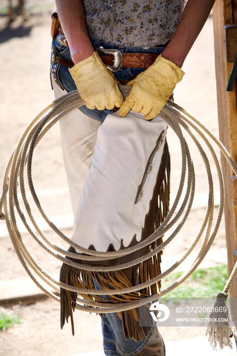 Woman in yellow gloves holding lasso