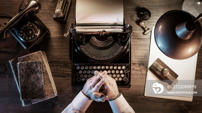 Journalist working in his vintage office at night