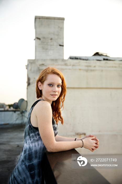 Portrait of smiling redhead woman standing outdoors