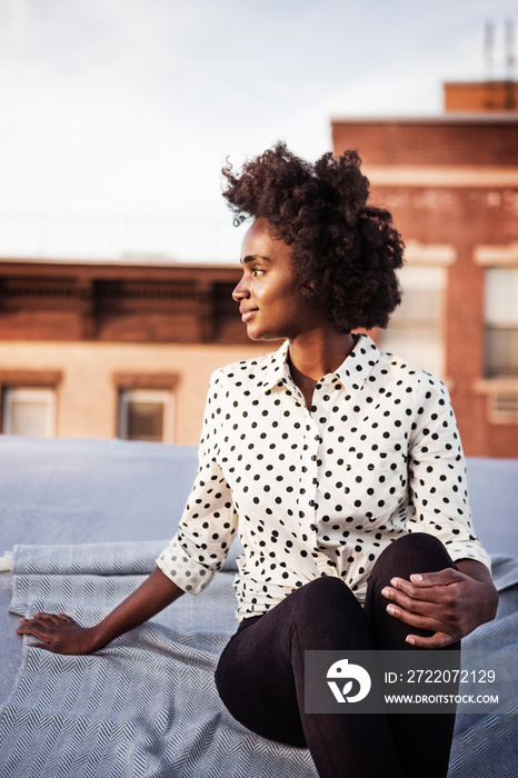 Young woman sitting on roof