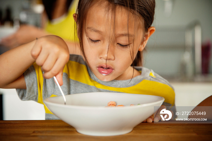 Girl (4-5) eating breakfast