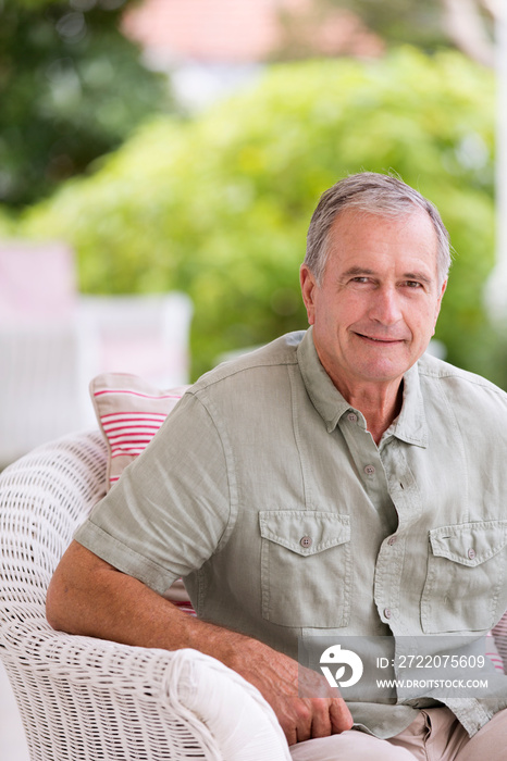 Portrait confident senior man on patio