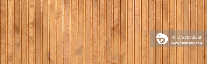 Close up of brown wooden fence panels. Many vertical wooden planks