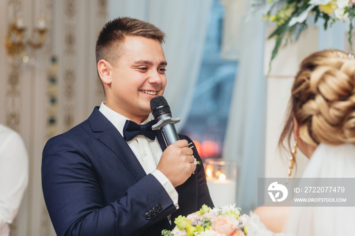 groom holding microphone and talking speech