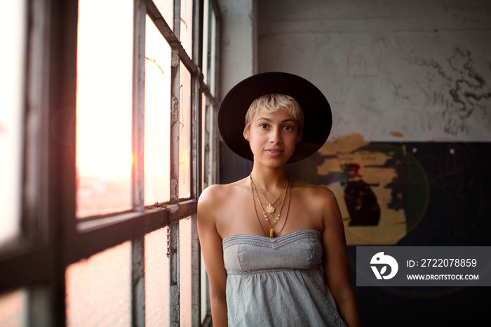 Portrait of young woman wearing hat