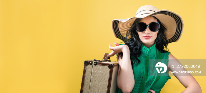 Young woman with a suitcase travel theme on a yellow background