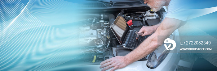 Mechanic using laptop for checking car engine. panoramic banner
