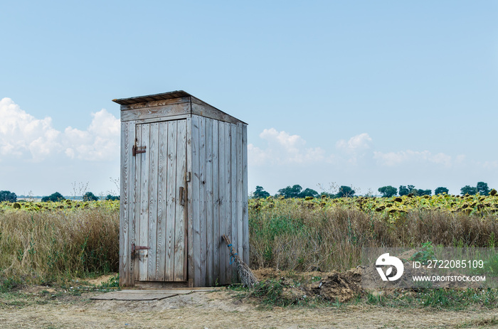 Old rural wooden toilet in the field